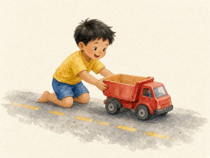A young child playing with a toy truck